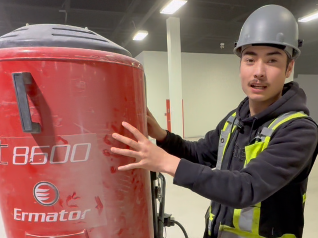 Worker cleaning pre-filter on Ermator S36 HEPA dust extractor
